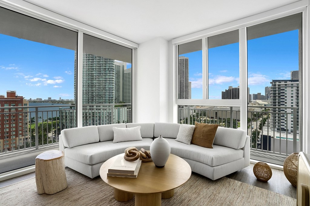 a living room with a view of a city and a couch and table