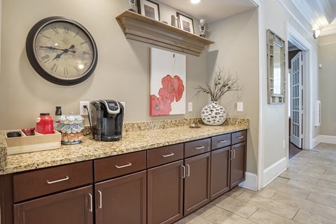 a kitchen with a counter and a clock on the wall