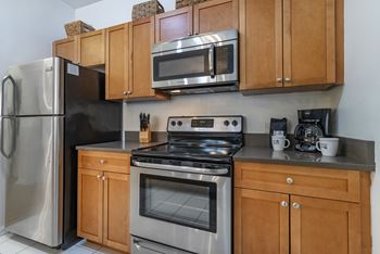 a kitchen with stainless steel appliances and wooden cabinets