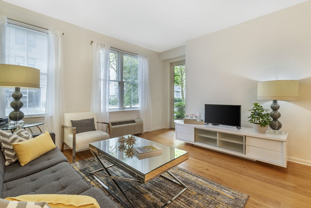 a living room with a couch and a coffee table and a television at Pier Village Apartments, Long Branch
