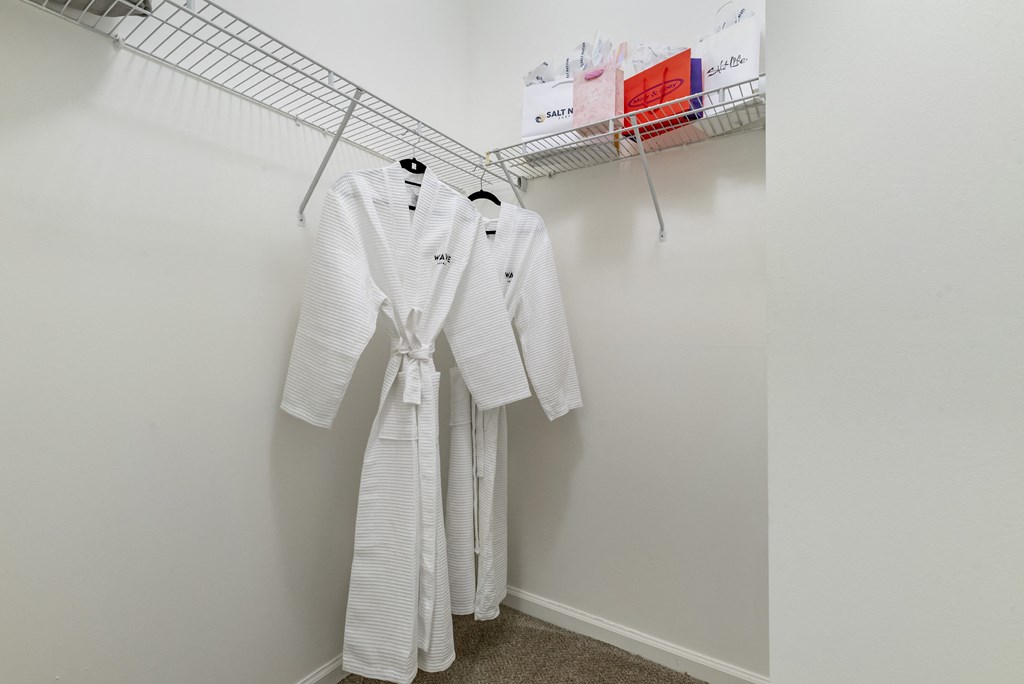 spacious closet with white robes and hangers in a studio apartment at Pier Village Apartments, Long Branch, NJ, 07740
