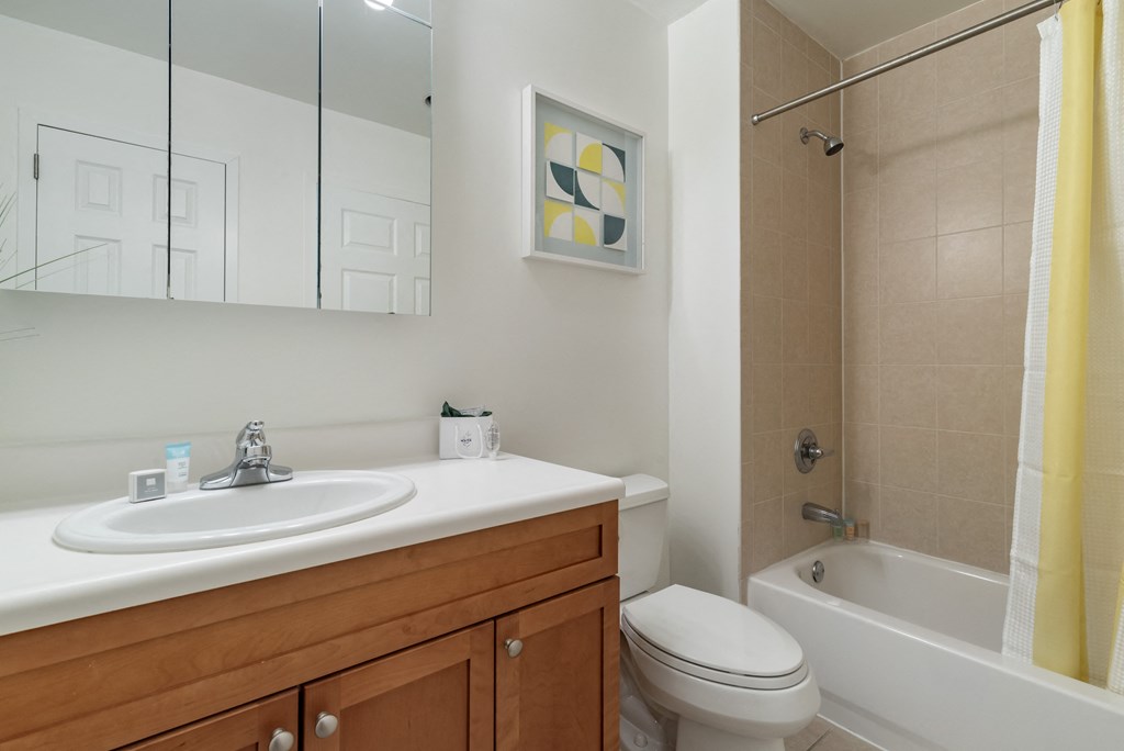 a bathroom with a sink and a toilet and a shower at Pier Village Apartments, Long Branch, NJ
