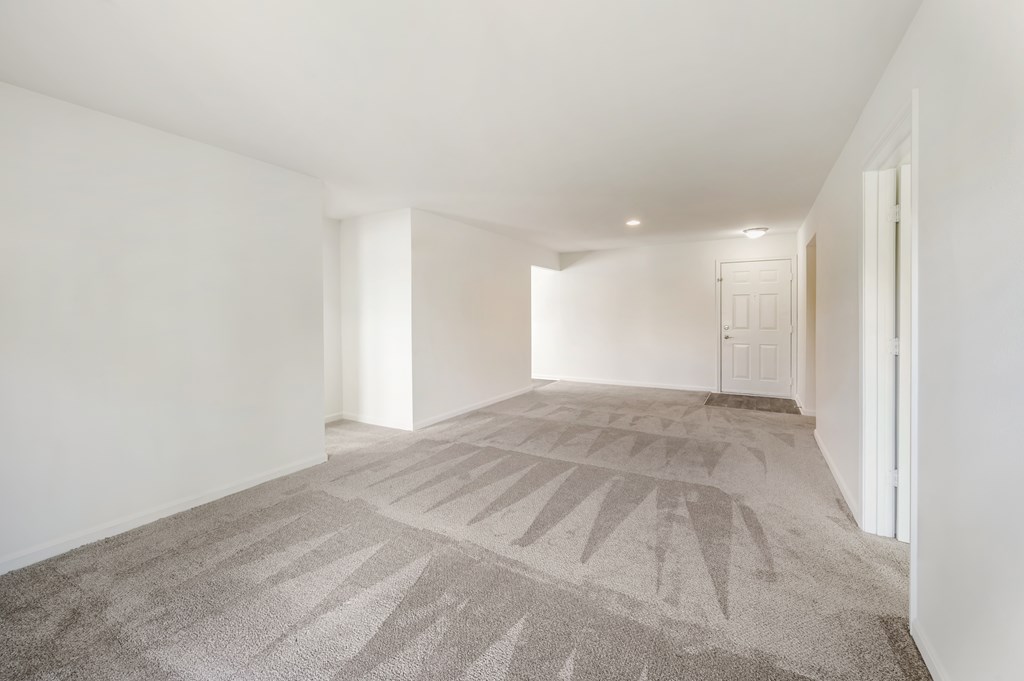 two twin beds in a bedroom with grey walls and a window
