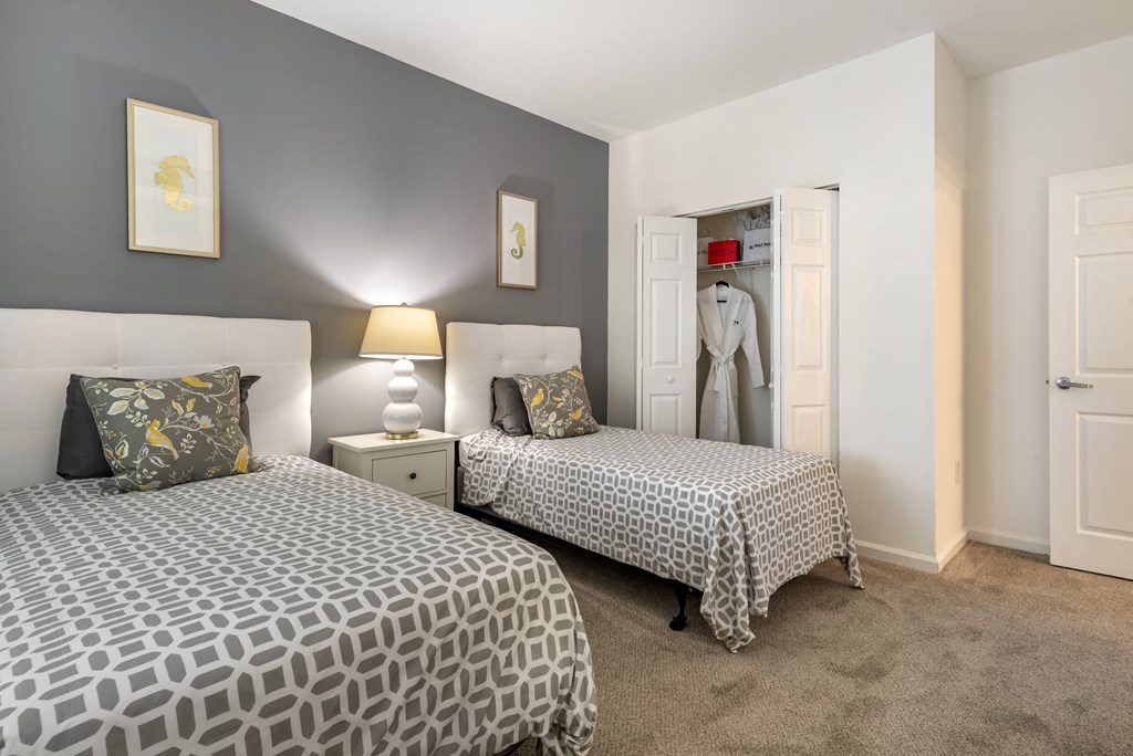 a bedroom with two beds and a closet