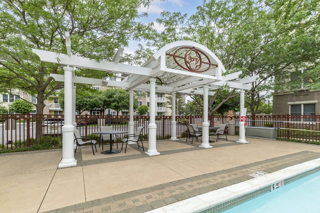 a gazebo with tables and chairs next to a swimming pool at Pier Village Apartments, New Jersey, 07740