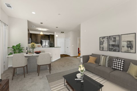A living room with a grey couch and a black coffee table.