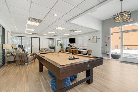 A pool table A pool table is in the middle of a room with a white ceiling and a door to the right. at Chatham Hill, New Jersey, 07928
