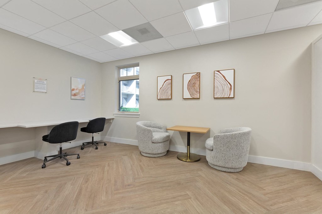 a waiting room with chairs and a table in front of a window at Copper and Quarry Village, Maryland, 21209