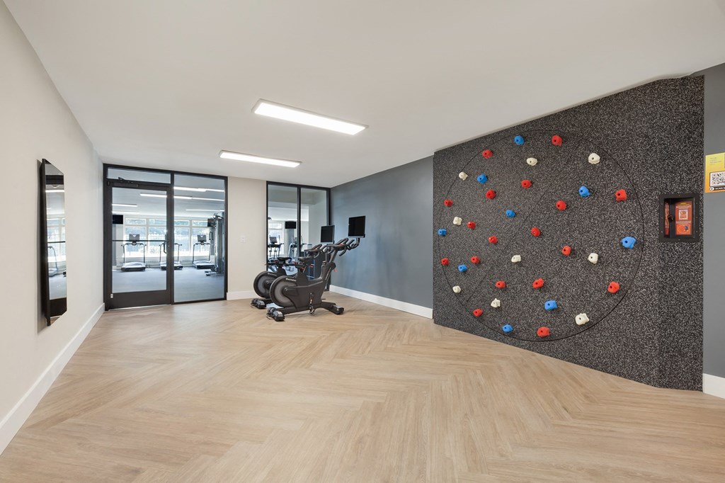 a rock climbing wall in a lobby with a chair at Copper and Quarry Village, Maryland, 21209