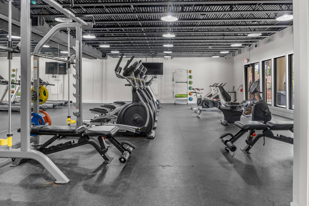 A gym with a variety of equipment including a leg press machine.