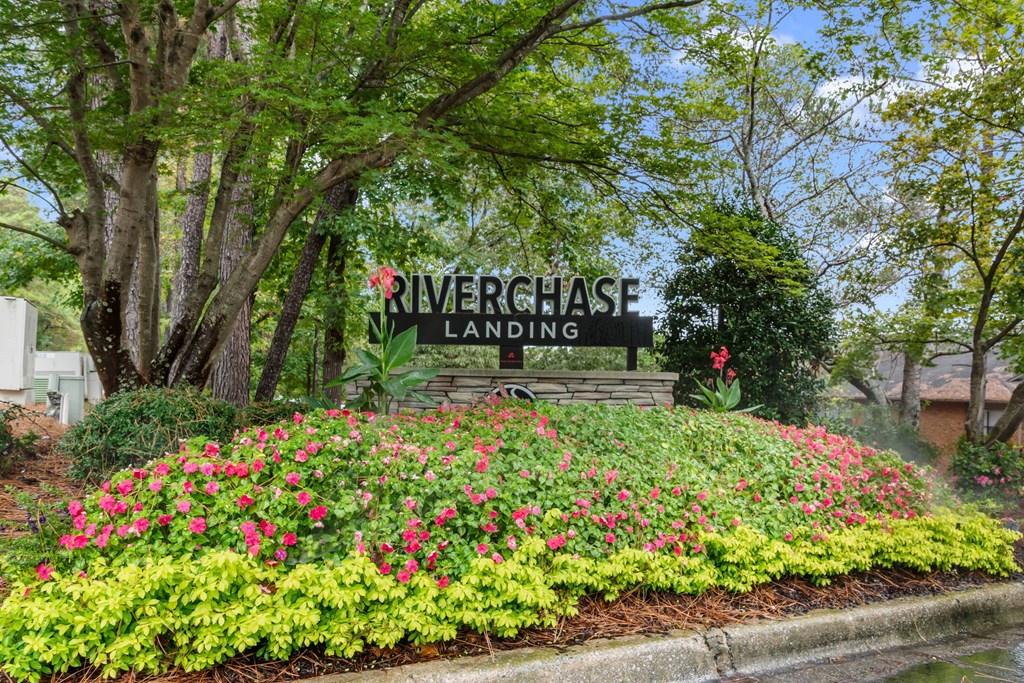 A sign that says "Riverchase Landing" is surrounded by flowers.