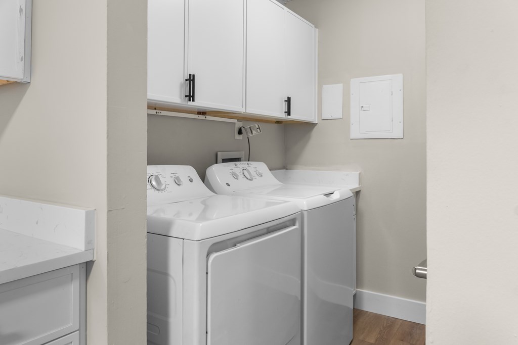A white washing machine and dryer in a laundry room.