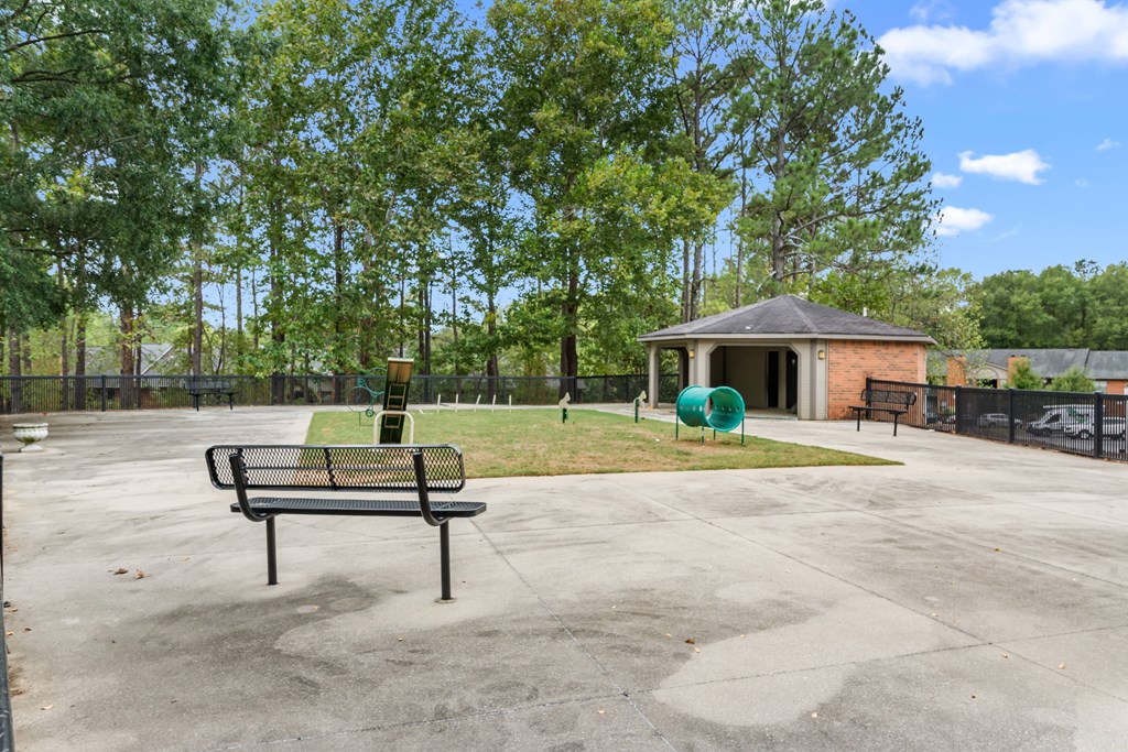 A park with a bench and a gazebo.