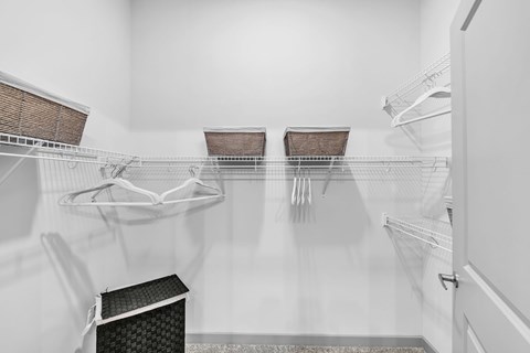 A clean, empty kitchen with white cabinets and a white refrigerator.