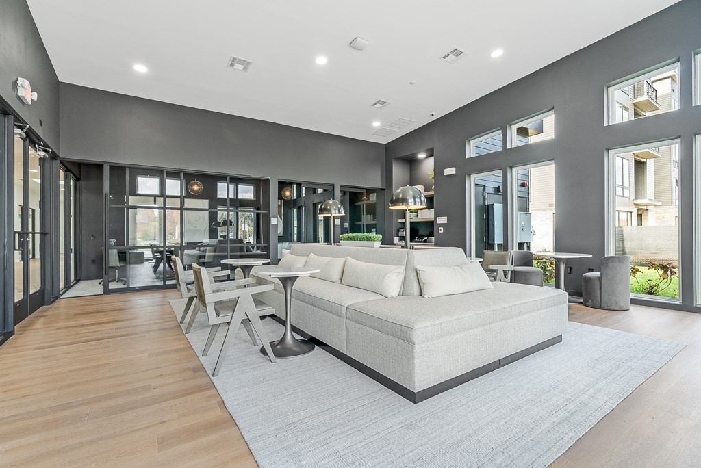 a living room with a couch and a table and chairs