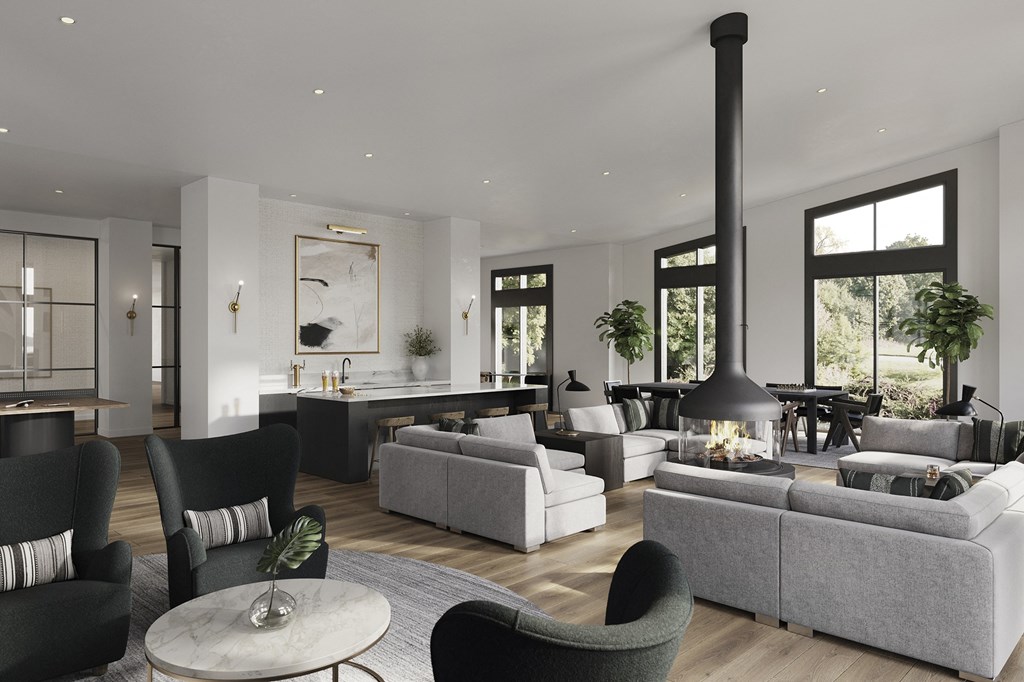 a living room with couches and chairs and a kitchen with a fireplace