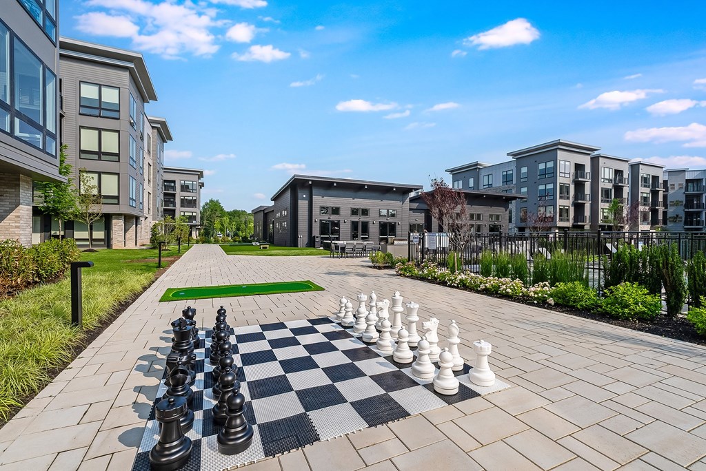 A giant chess board in the middle of a courtyard.