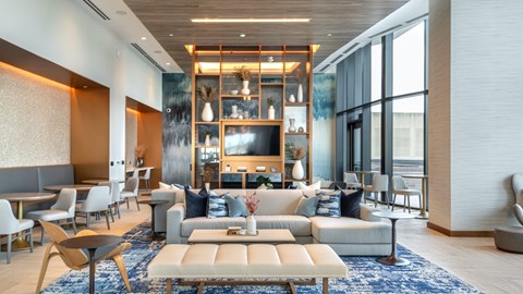 A modern living room with a large sectional sofa and a coffee table.