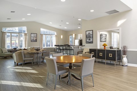 A modern dining room with a wooden table and chairs.