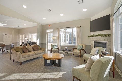 A living room with a couch, chairs, and a fireplace.