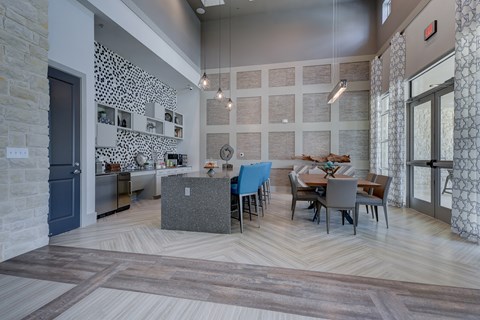a dining room and kitchen with a table and chairs