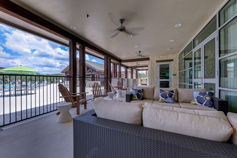 a large living room with a white couch and a balcony