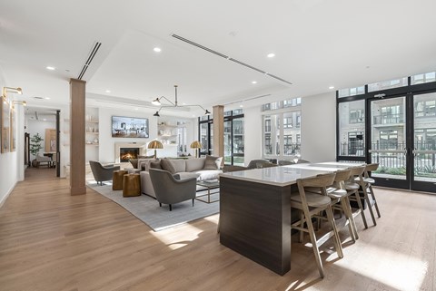 A modern kitchen with a large island and a view of the city.