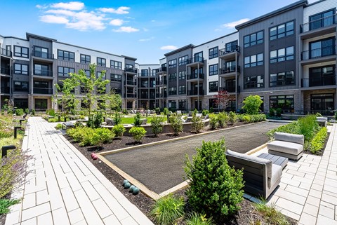 A sunny day at a modern apartment complex with a well-maintained courtyard.
