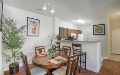 a dining room and kitchen with a table and chairs