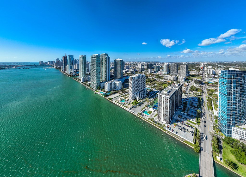 A cityscape with a body of water in the foreground.