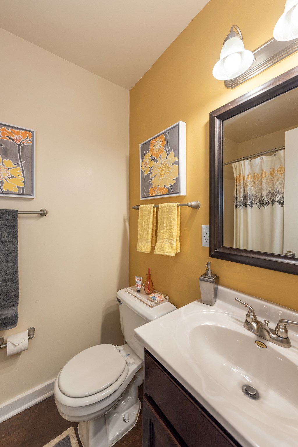 a bathroom with a sink toilet and mirror