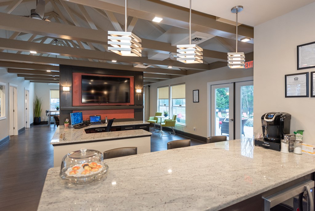a view of a kitchen and living room from behind a counter with a counter top