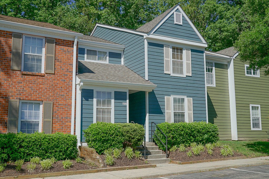 a row of houses with blue and green siding