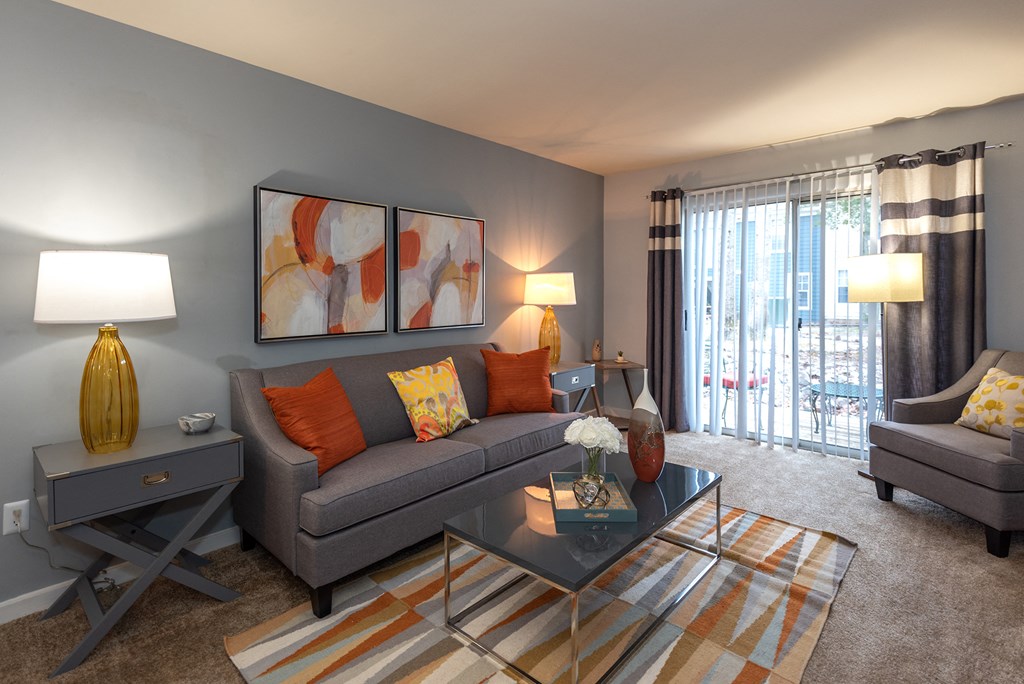 a living room with a gray couch and a coffee table