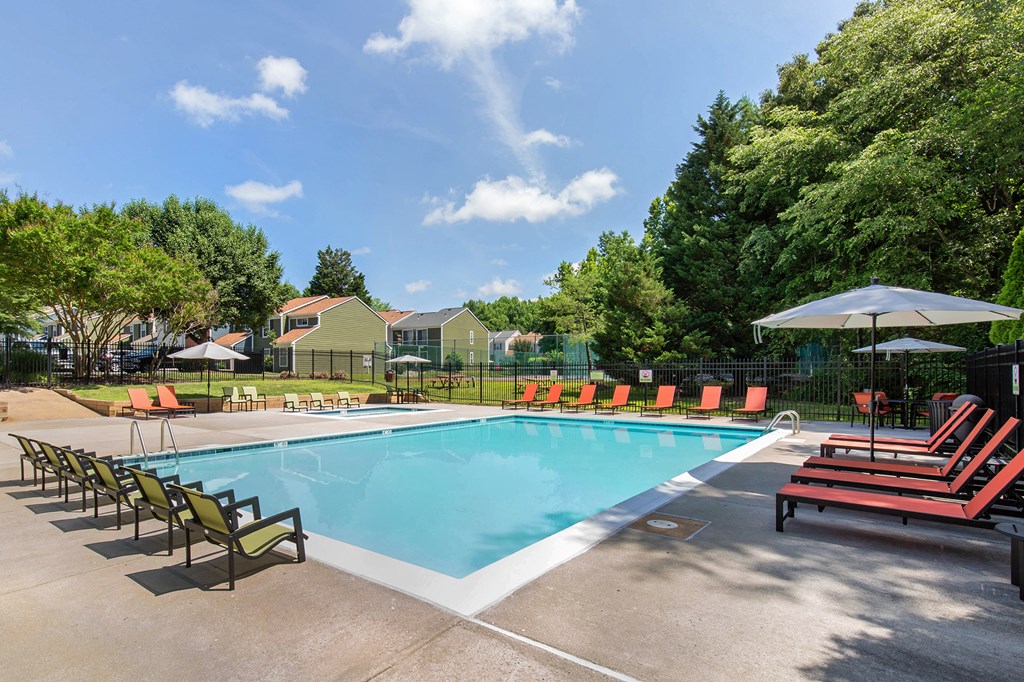 our apartments have a resort style pool with chairs and umbrellas
