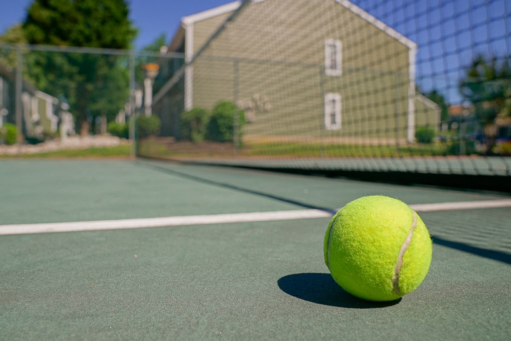 a tennis ball sitting on a tennis court