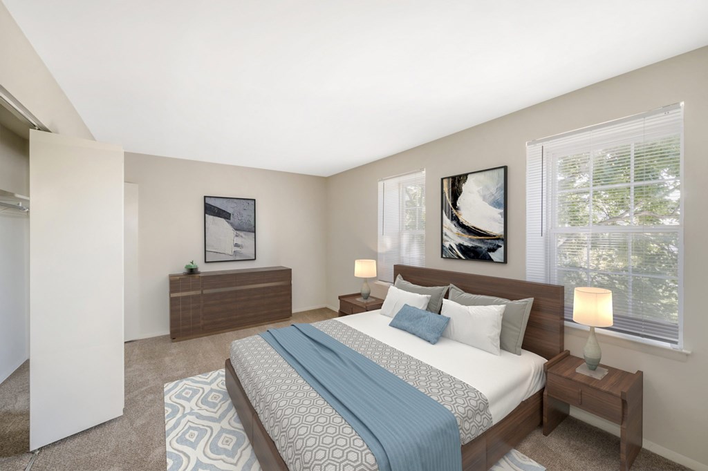 A bedroom with a bed, nightstand, and two lamps.