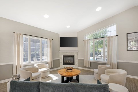 A living room with a grey couch, a coffee table, and a fireplace.