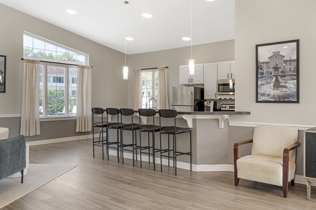 A kitchen with a bar area and a chair.