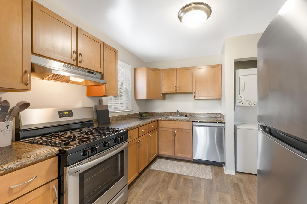 A kitchen with wooden cabinets and stainless steel appliances.