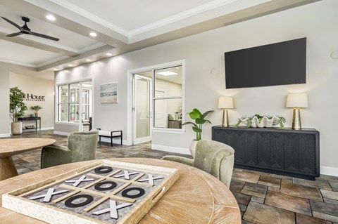 A living room with a wooden table and a carpeted floor.