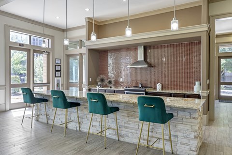 a kitchen with green bar stools in front of a stone counter top