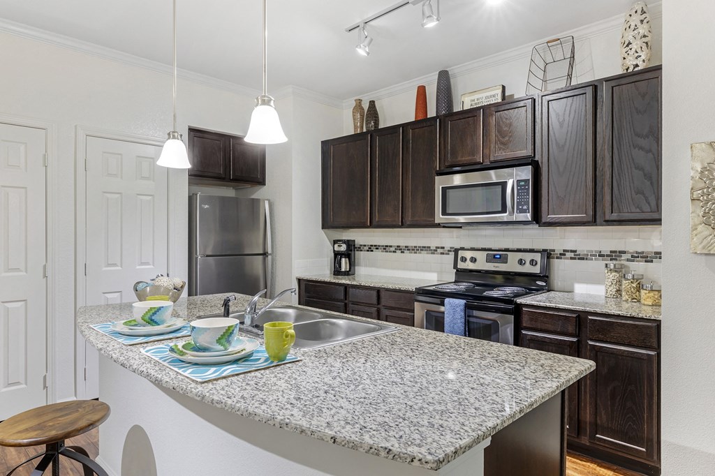 Modern kitchen with stainless steel appliances and granite counter tops at Mansfield on the Green, Milwaukie, 76063