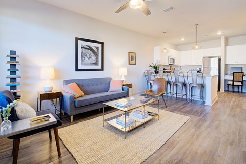 A living room with a grey couch and a coffee table.