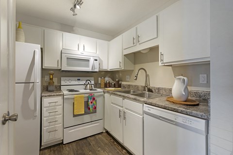 the preserve at ballantyne commons apartment kitchen with white cabinets and appliances