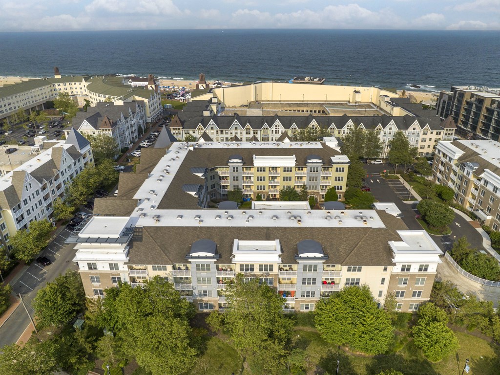 an aerial view of the building with the ocean in the background at Pier Village Apartments, New Jersey