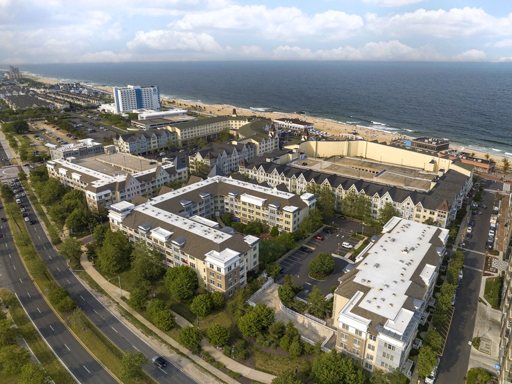 an aerial view of a city with the ocean in the background at Pier Village Apartments, Long Branch, NJ