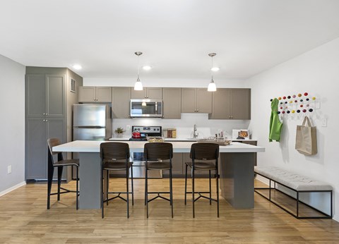 A kitchen with a table and chairs in the middle of the room.