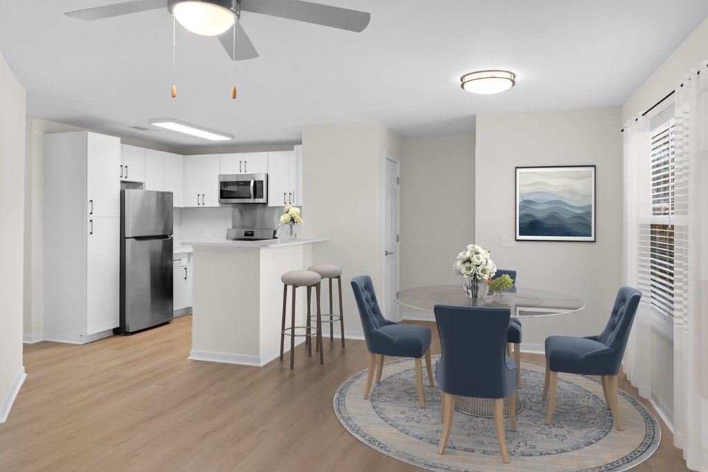 A modern kitchen with a dining table set for four. A modern kitchen with a dining table set for four. at Reflection Pointe, Flowood, MS