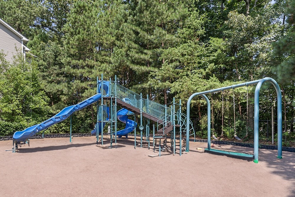 a playground with a blue slide and a staircase at Spotswood Commons, Williamsburg, VA  